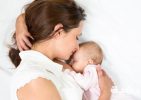 mother breastfeeding baby girl scaled